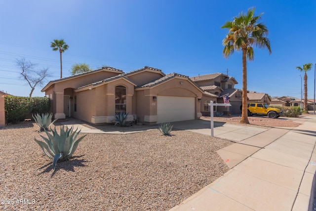 mediterranean / spanish home featuring stucco siding, concrete driveway, an attached garage, and a tile roof