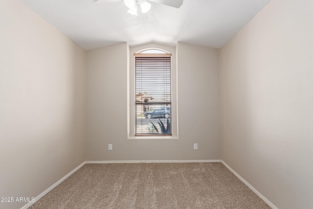 unfurnished room with ceiling fan, baseboards, carpet, and vaulted ceiling