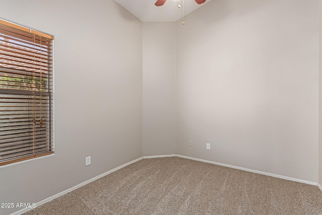 unfurnished room with baseboards, a ceiling fan, and carpet floors