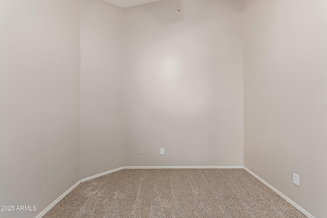 carpeted empty room with baseboards