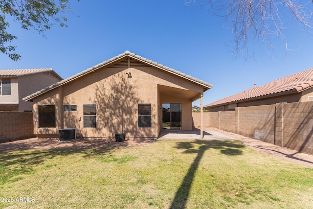 back of house with cooling unit, a yard, a fenced backyard, stucco siding, and a patio area