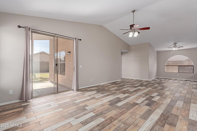 empty room with lofted ceiling, wood finished floors, baseboards, and ceiling fan