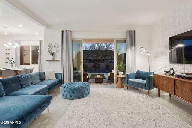 living room featuring a chandelier, recessed lighting, and wood finished floors