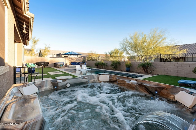 view of pool featuring a hot tub, a patio area, and a fenced backyard