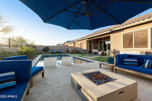 view of swimming pool featuring a fenced backyard, a patio area, an outdoor living space with a fire pit, and a fenced in pool