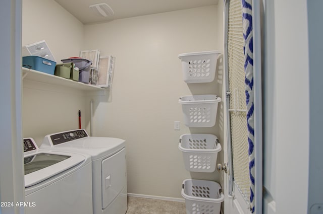 laundry area featuring separate washer and dryer and light tile patterned flooring