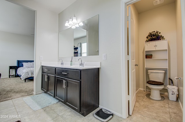 bathroom with tile patterned flooring, vanity, and toilet