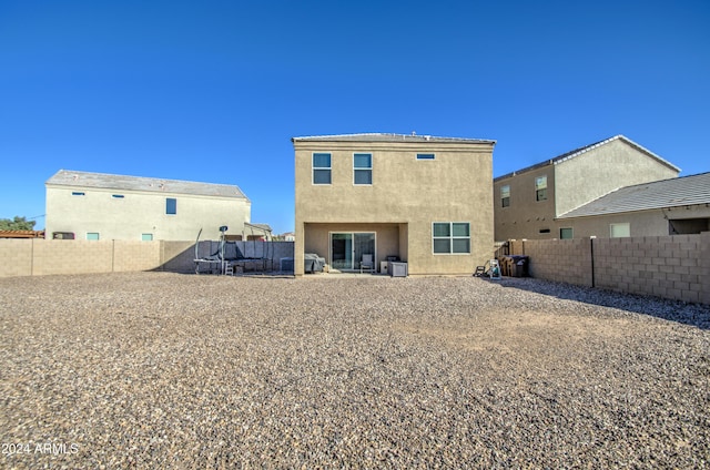 rear view of house with central air condition unit and a patio area