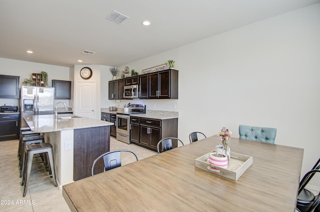 dining room with sink and light tile patterned flooring