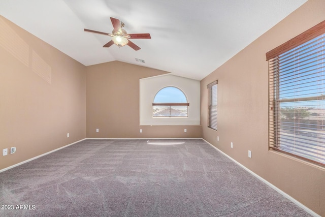 unfurnished room featuring visible vents, carpet flooring, baseboards, ceiling fan, and vaulted ceiling