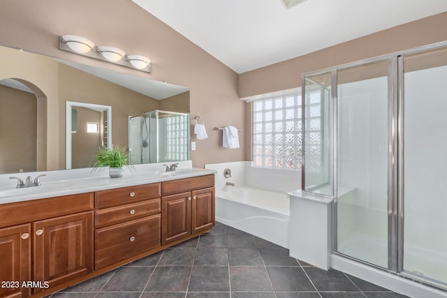 full bathroom with a sink, double vanity, a stall shower, and tile patterned floors