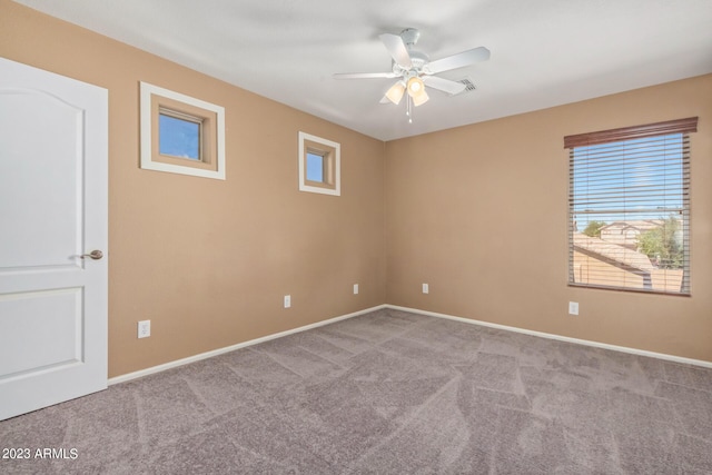 carpeted spare room with baseboards and ceiling fan