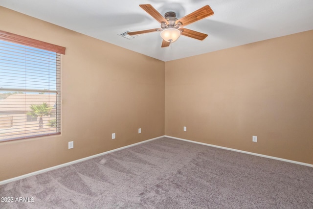 empty room with a ceiling fan, visible vents, carpet floors, and baseboards