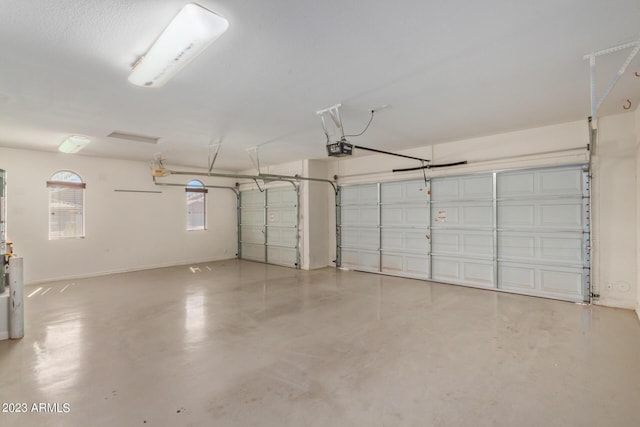 garage featuring a garage door opener and baseboards