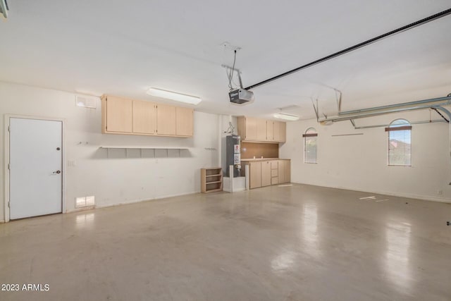 garage featuring gas water heater and a garage door opener