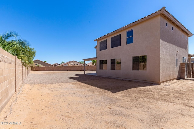 back of property with stucco siding, a patio, and a fenced backyard