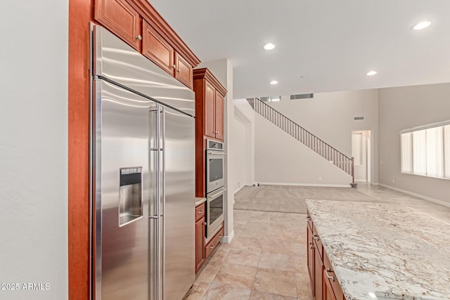 4724 S Anitole Way, Mesa, AZ 85212 - kitchen with appliances with stainless steel finishes, open floor plan, light stone countertops, recessed lighting, and brown cabinetry