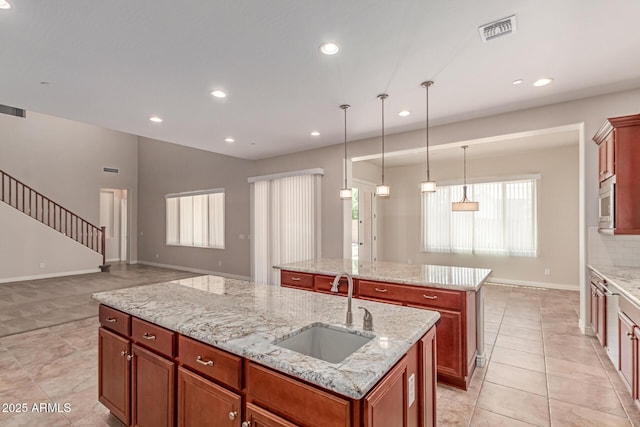 4724 S Anitole Way, Mesa, AZ 85212 - kitchen with an island with sink, open floor plan, recessed lighting, light tile patterned floors, and decorative light fixtures