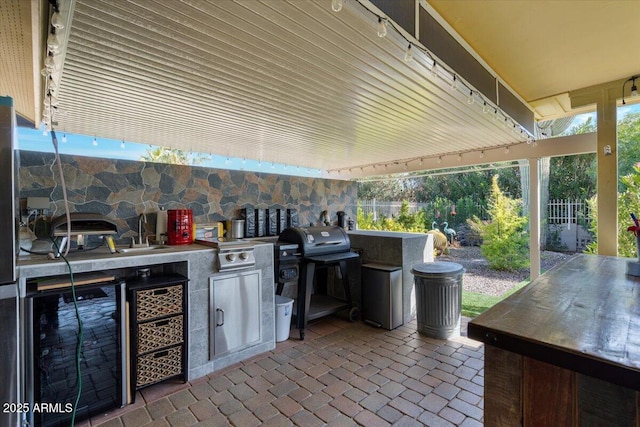 view of patio / terrace featuring area for grilling, sink, beverage cooler, and an outdoor kitchen