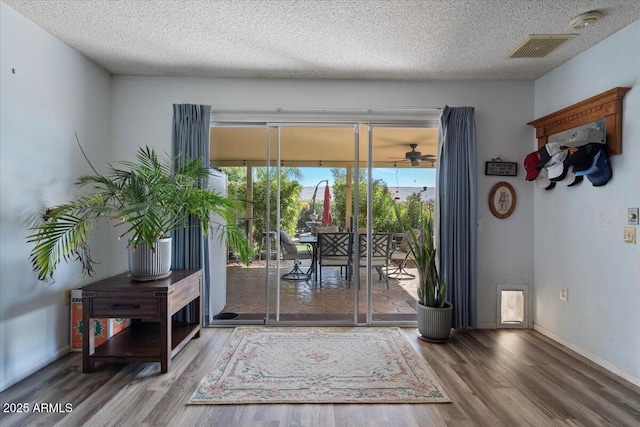 entryway with wood-type flooring and a textured ceiling