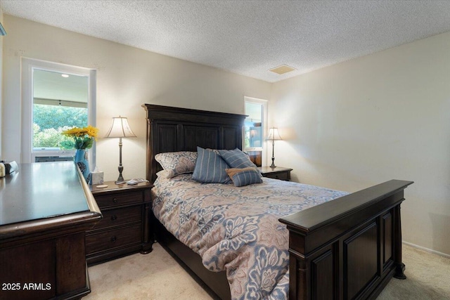 carpeted bedroom featuring a textured ceiling