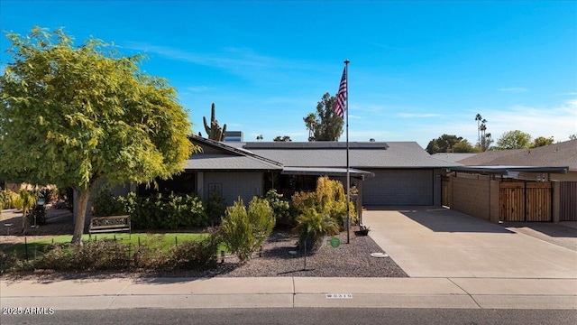 obstructed view of property featuring a garage and solar panels