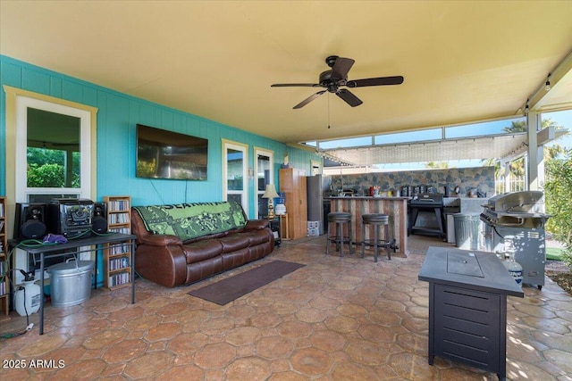 view of patio / terrace featuring ceiling fan, a grill, outdoor lounge area, and an outdoor bar