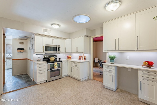 kitchen featuring appliances with stainless steel finishes and white cabinets