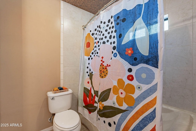 bathroom with a shower with curtain and toilet