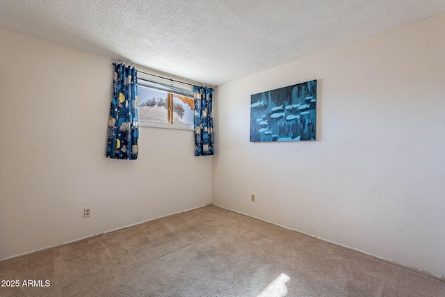 carpeted spare room featuring a textured ceiling