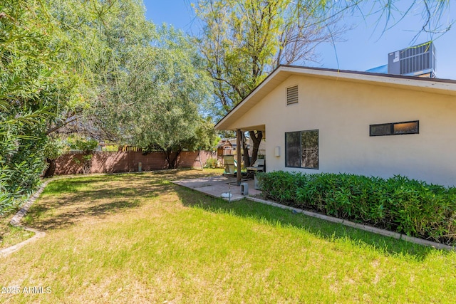 view of yard featuring central AC unit and a patio