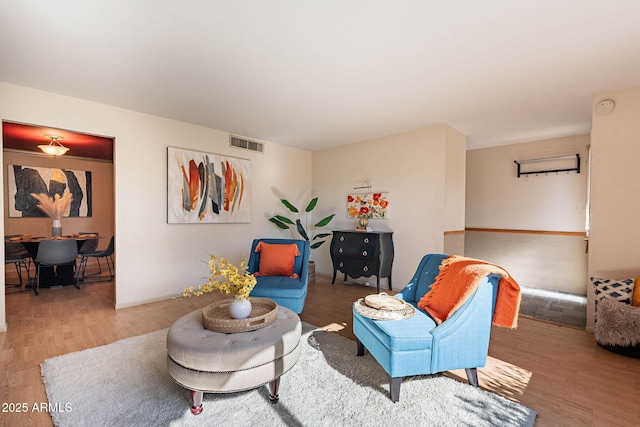 sitting room with hardwood / wood-style floors