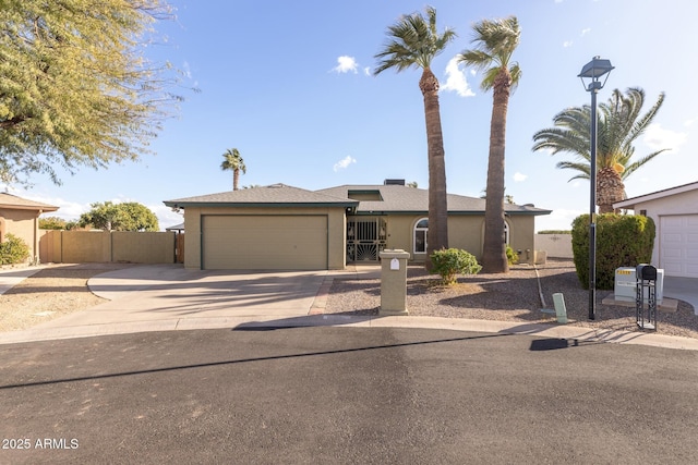 ranch-style house with a garage, fence, concrete driveway, and stucco siding