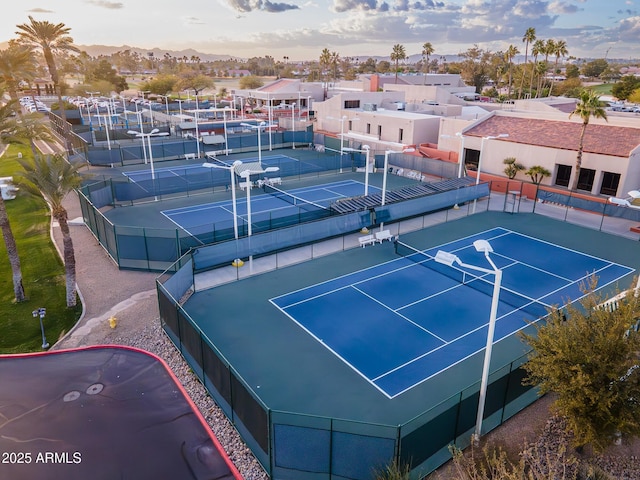 view of sport court with fence and a residential view
