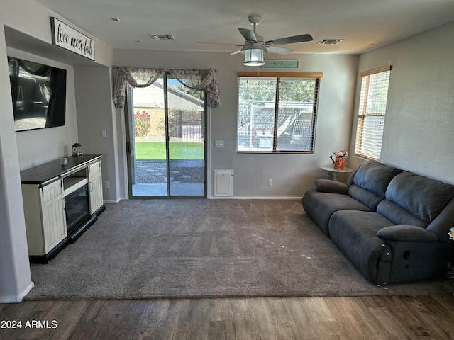 living room featuring hardwood / wood-style flooring, ceiling fan, and plenty of natural light