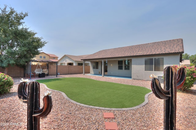 rear view of property with a pergola, a yard, and a patio