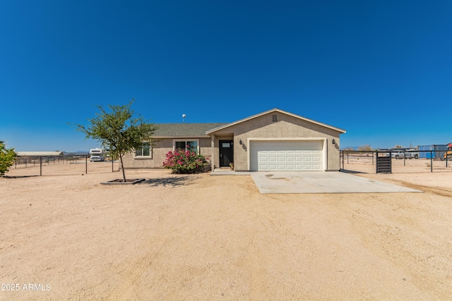 20750 E Chase Ct, Florence, AZ 85132 - ranch-style home with concrete driveway, stucco siding, and an attached garage