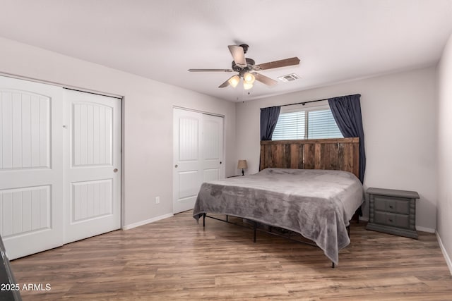 20750 E Chase Ct, Florence, AZ 85132 - bedroom with wood finished floors, two closets, and a ceiling fan
