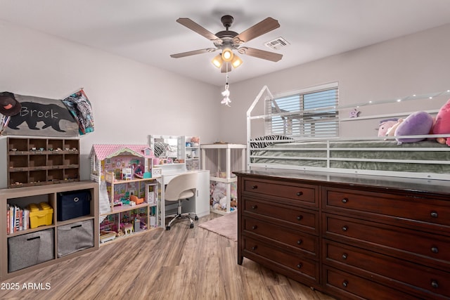 20750 E Chase Ct, Florence, AZ 85132 - bedroom with wood finished floors, an office area, and a ceiling fan