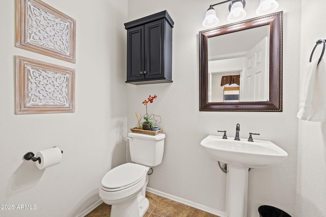 bathroom with tile patterned flooring and toilet