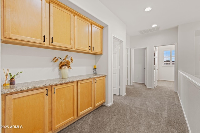 hallway featuring light colored carpet