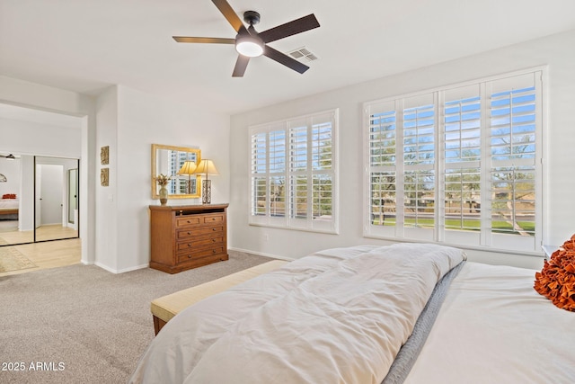 bedroom with ceiling fan and light colored carpet