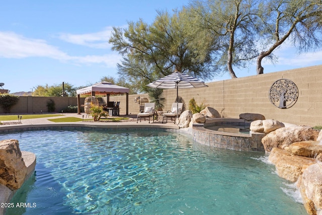 view of swimming pool featuring an in ground hot tub, a gazebo, and pool water feature