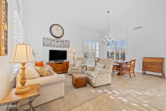 tiled living room featuring high vaulted ceiling and an inviting chandelier