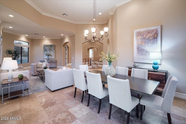 dining space with ornamental molding and an inviting chandelier