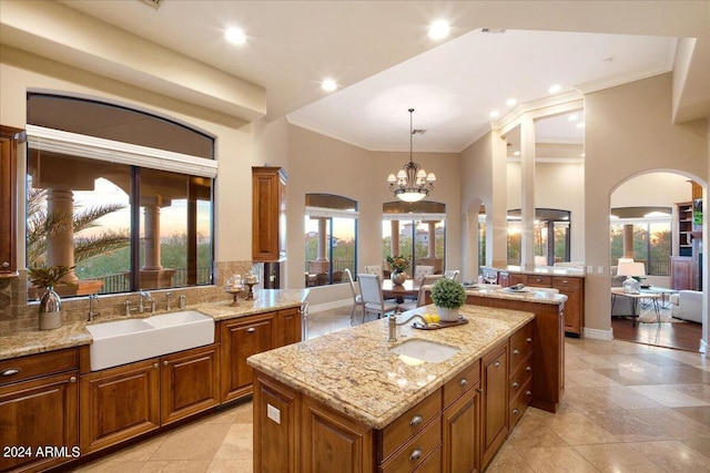 kitchen featuring sink, a center island, and light stone countertops