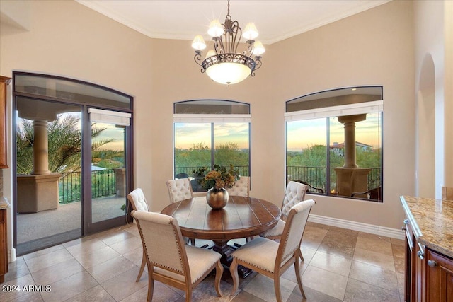 dining area with ornamental molding, a healthy amount of sunlight, and a notable chandelier