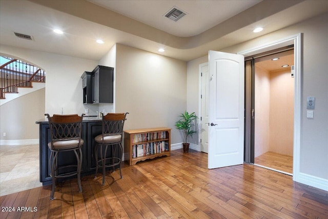 bar featuring dark hardwood / wood-style flooring