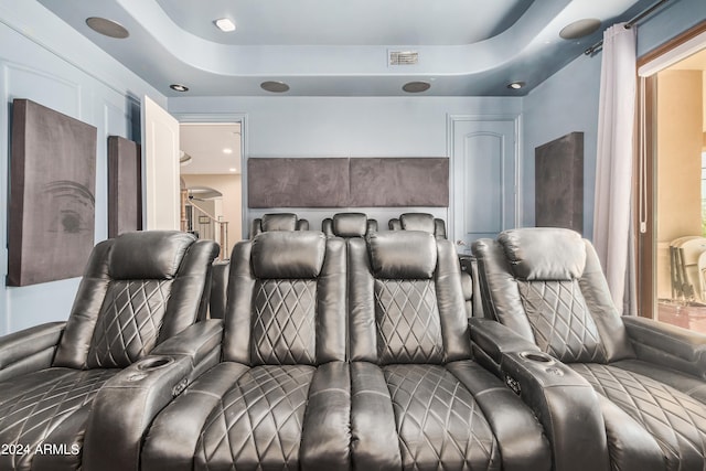 home theater featuring a raised ceiling