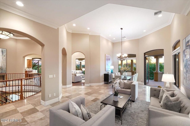 living room with a high ceiling, a notable chandelier, and ornamental molding